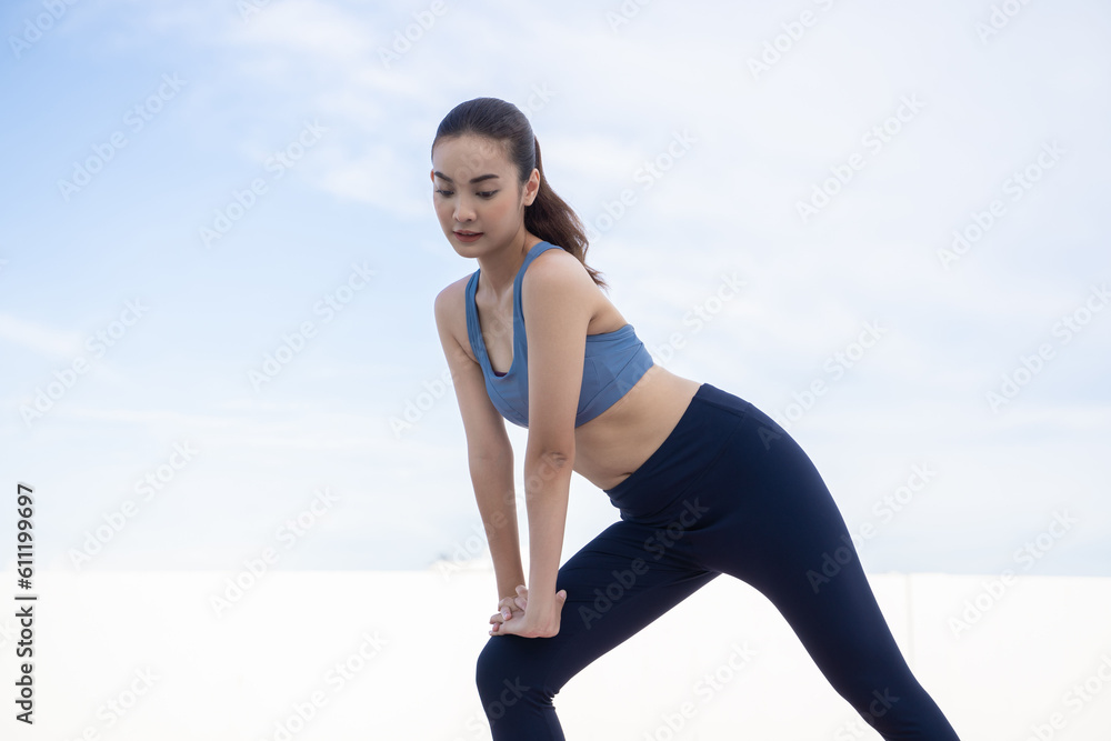 Young beauty Asian woman stretching workout outdoor rooftop. She warming up