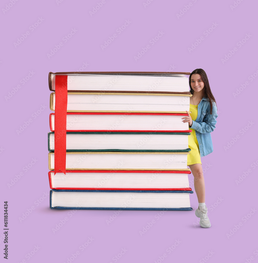 Happy young woman and stack of big books on lilac background