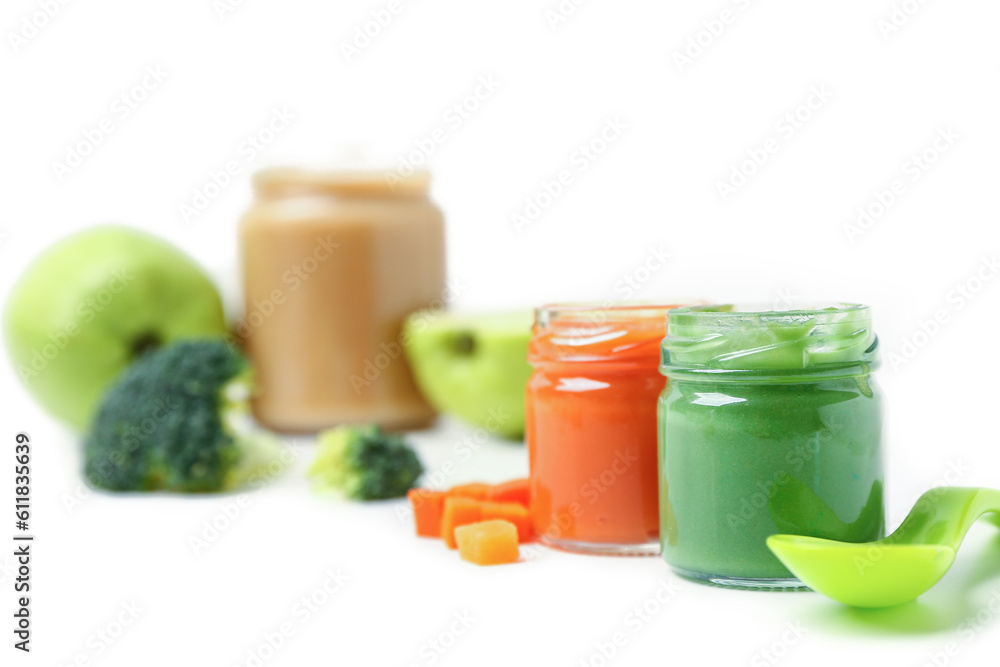 Jars of healthy baby food on white background