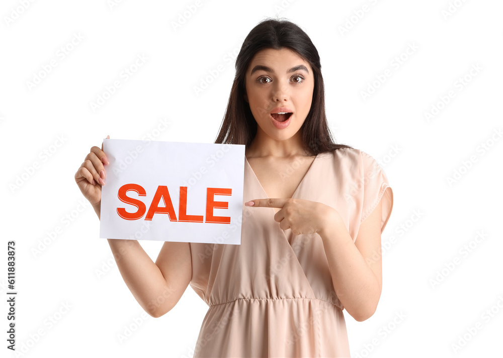 Surprised female seller pointing at sale sign on white background