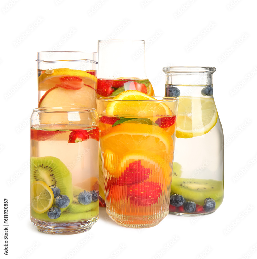 Glasses and bottles of infused water with different sliced fruits on white background