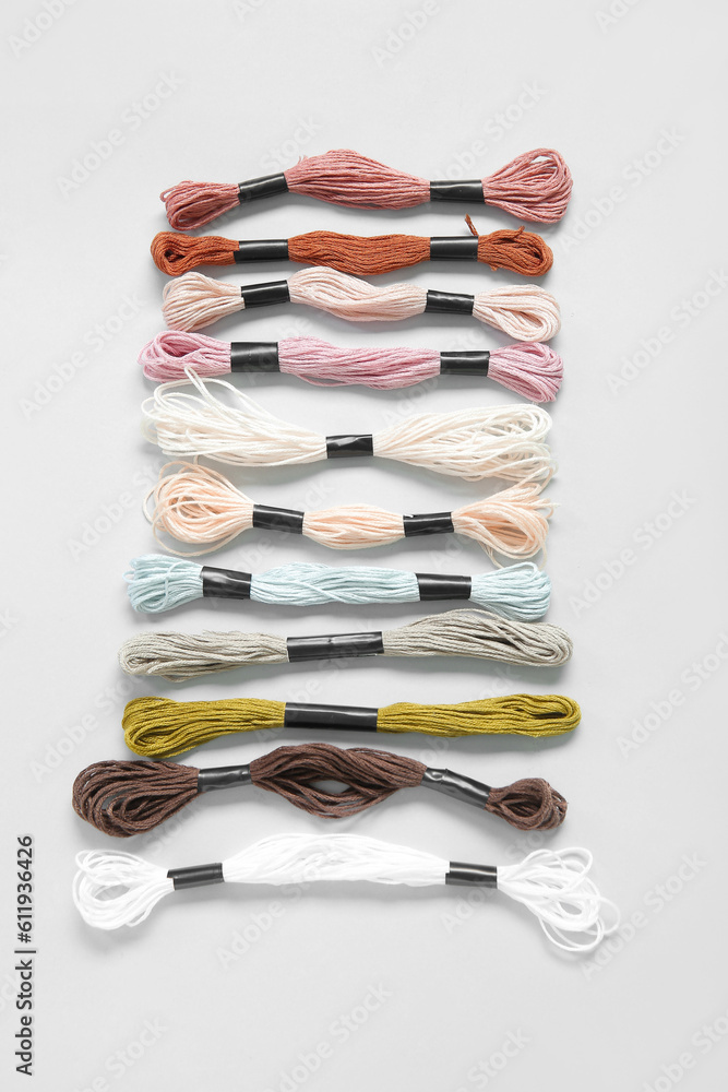 Different colorful mouline threads on white background