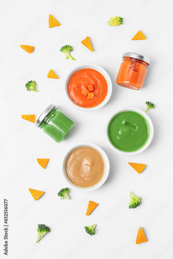 Composition with healthy baby puree and cut vegetables on white background