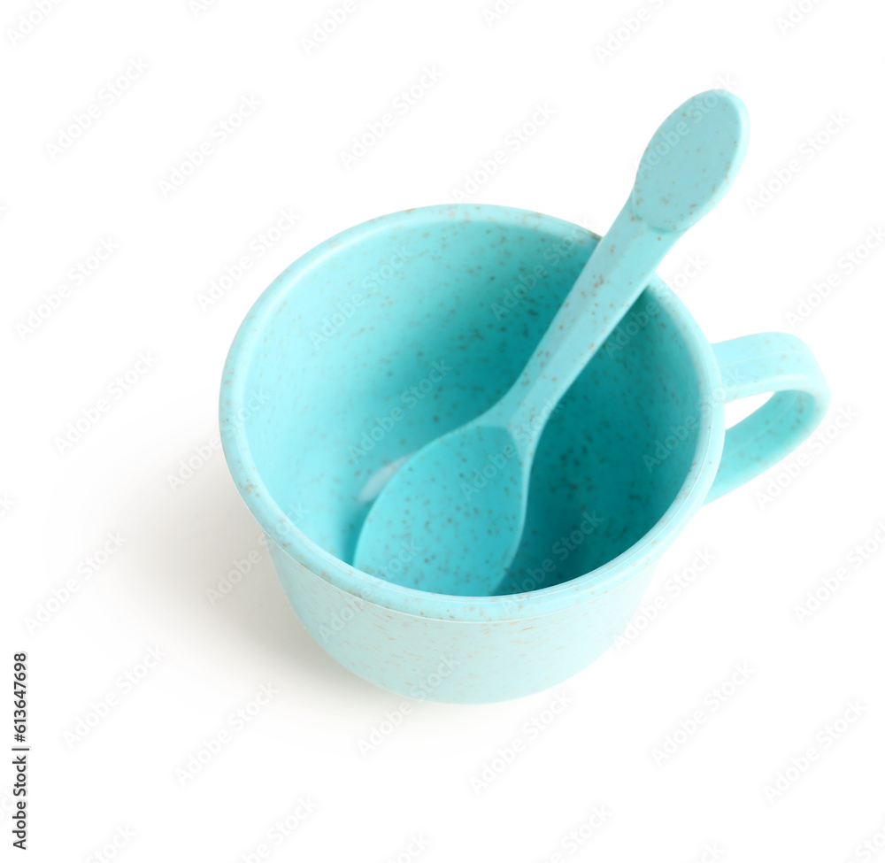 Blue cup with spoon isolated on white background. Childrens Day celebration