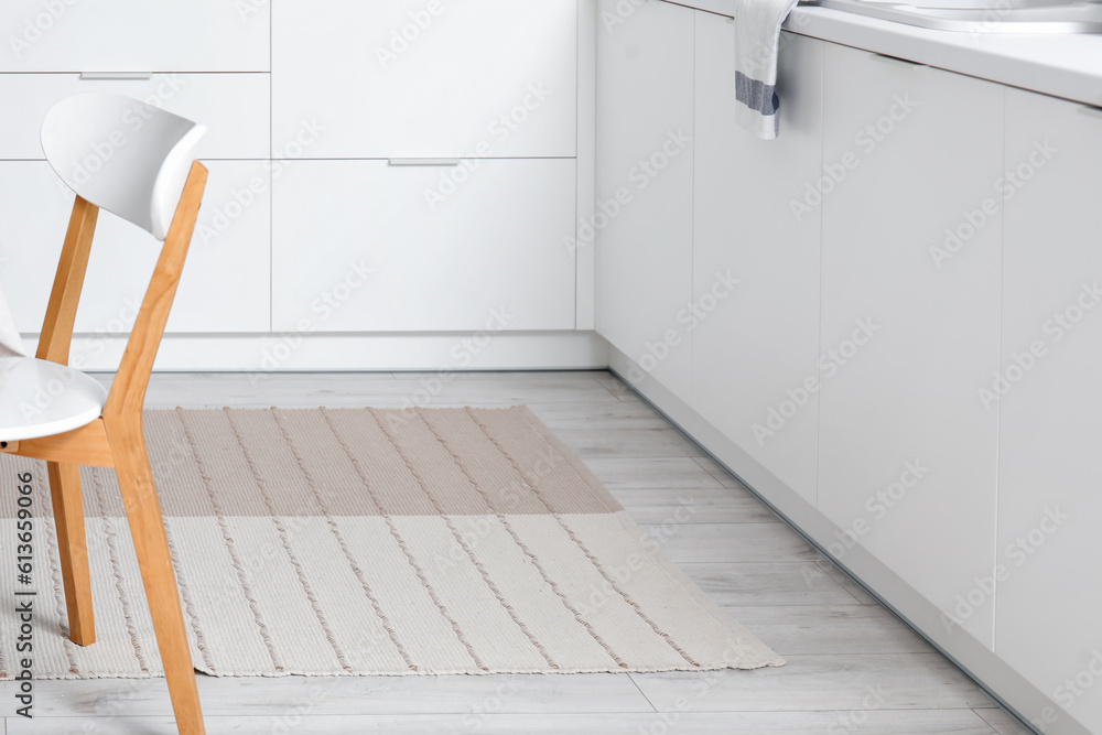Stylish beige carpet in interior of modern kitchen