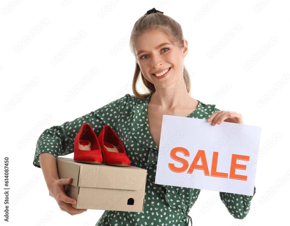 Young woman with shoes and sale sign on white background