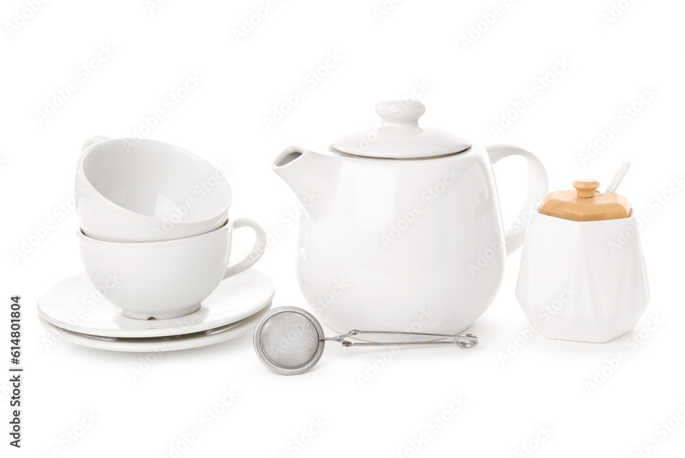 Teapot, cups, sugar bowl and tea infuser isolated on white background