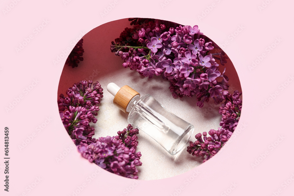 Composition with bottle of lilac essential oil and flowers on pink background, closeup