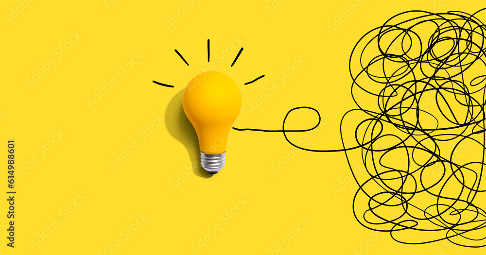 Clarifying complex ideas theme with light bulb - Flat lay