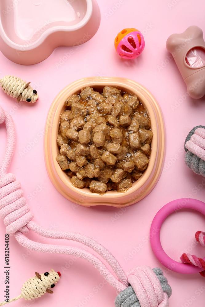 Composition with different pet care accessories and wet food on pink background