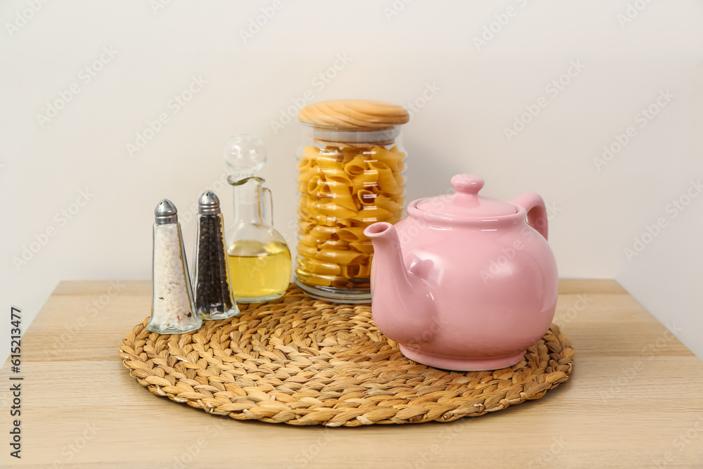 Composition with teapot and different kitchen stuff on wooden table