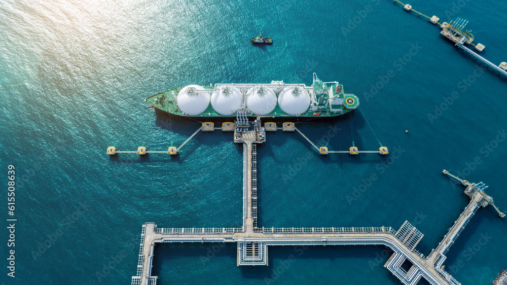 LNG (Liquified Natural Gas) tanker anchored in Gas terminal gas tanks for storage. Oil Crude Gas Tan