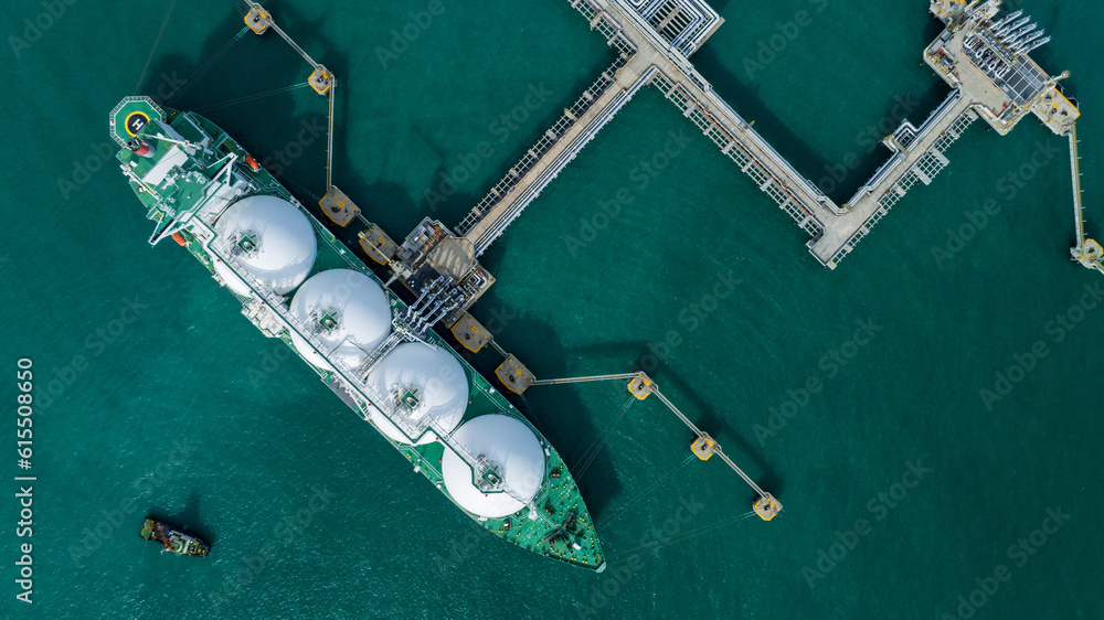 LNG (Liquified Natural Gas) tanker anchored in Gas terminal gas tanks for storage. Oil Crude Gas Tan