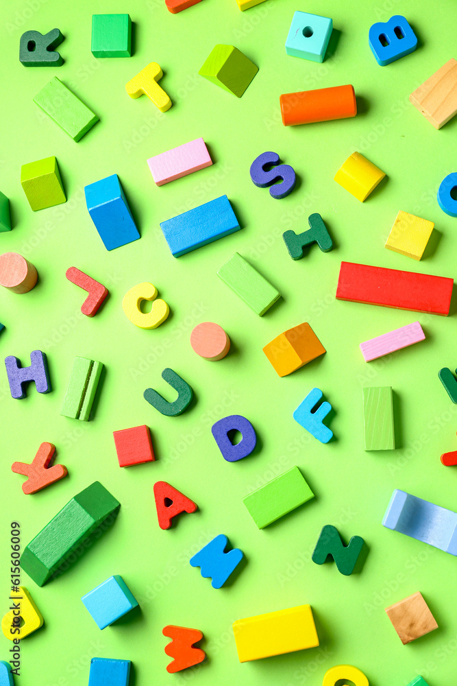Wooden letters with colorful blocks on green background. Childrens Day celebration