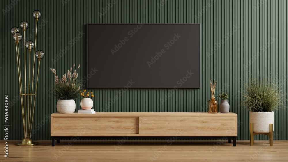 Mockup a cabinet TV wall mounted on dark green wooden slatted wall background.