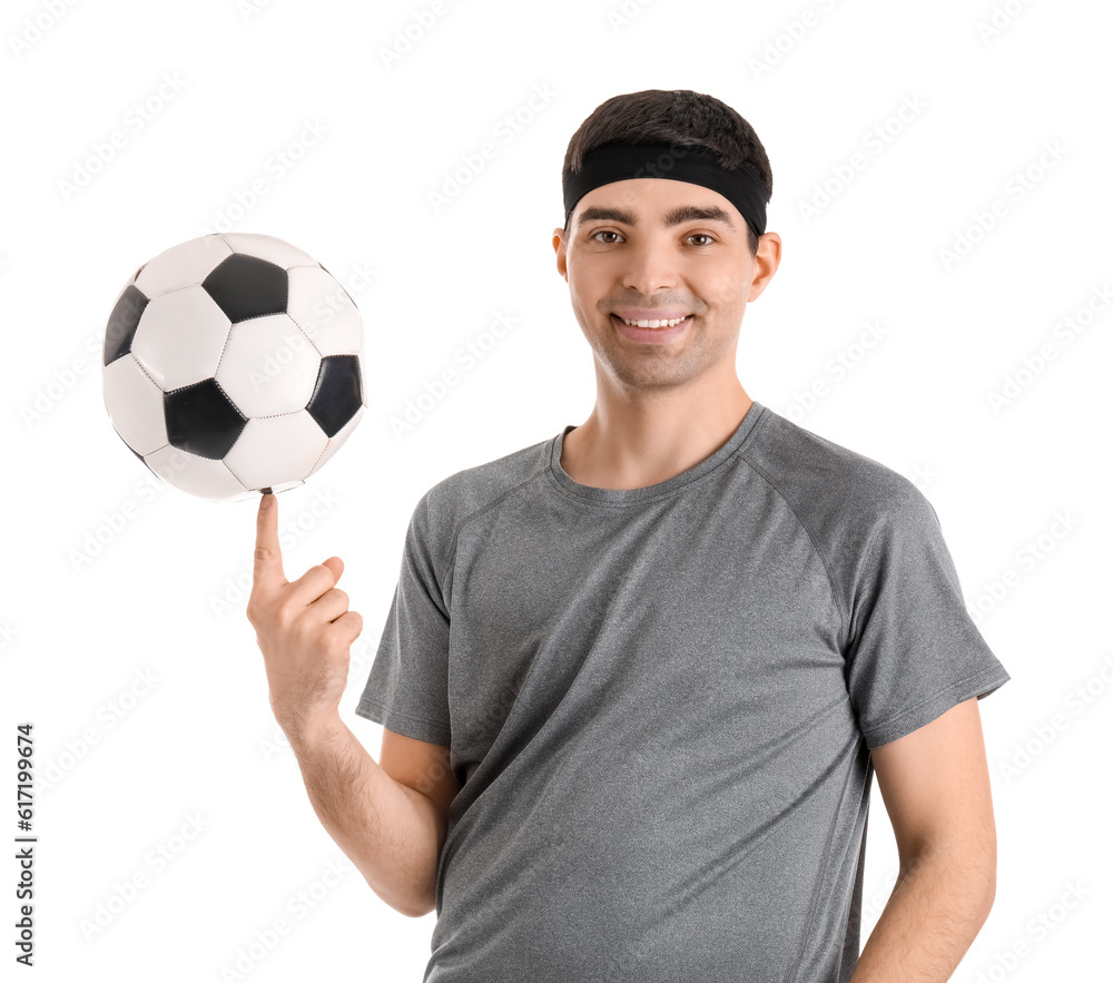 Sporty young man with soccer ball on white background. Balance concept