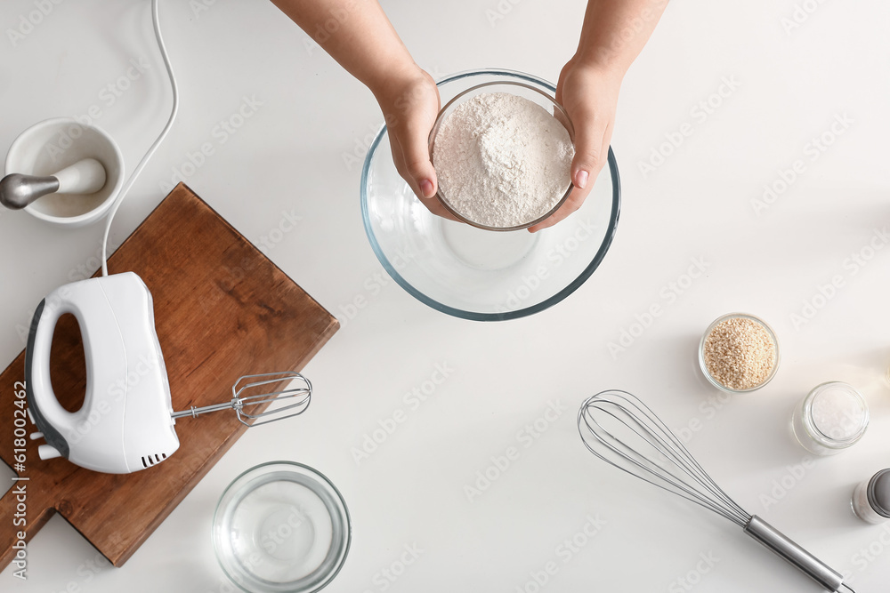 Woman preparing dough for Italian Grissini on white background