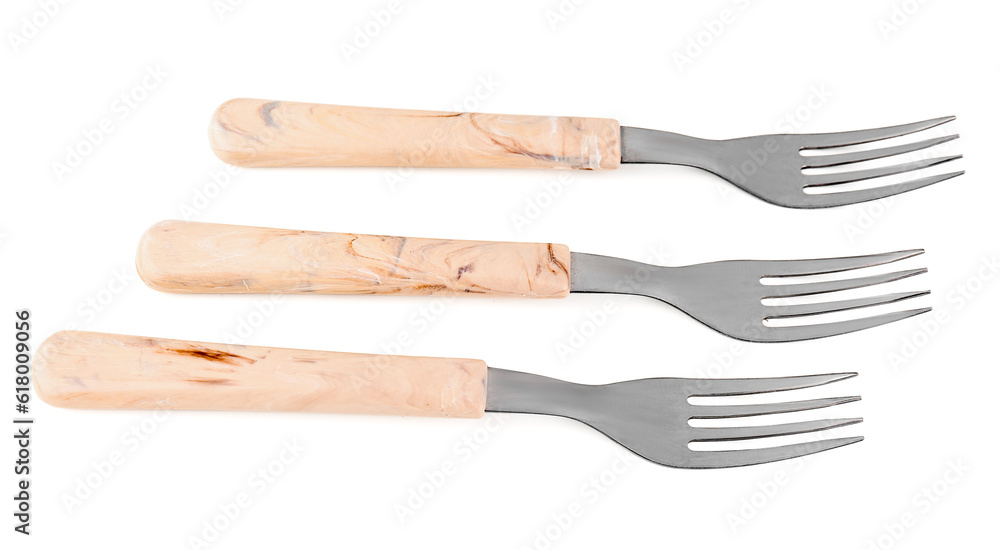 Stainless steel fork with plastic handles on white background