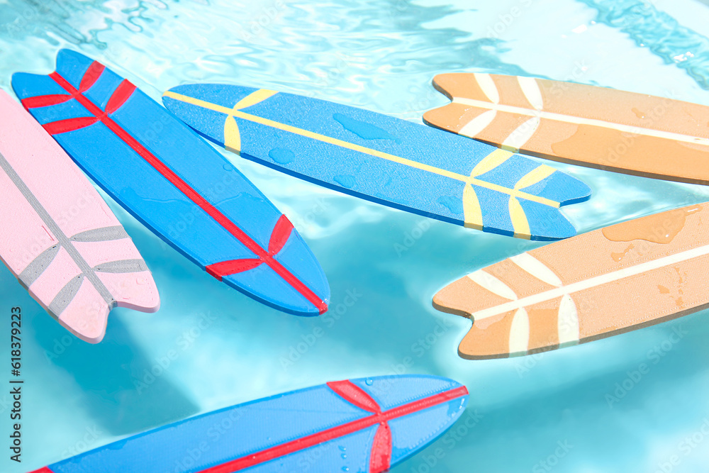 Many different mini surfboards in water