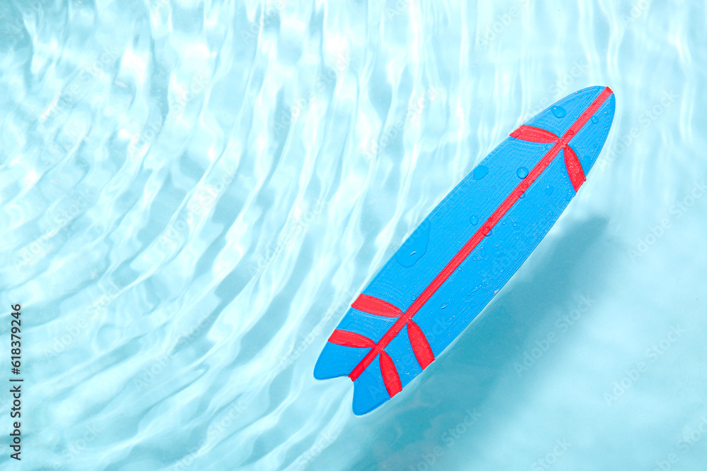 Mini blue surfboard in water