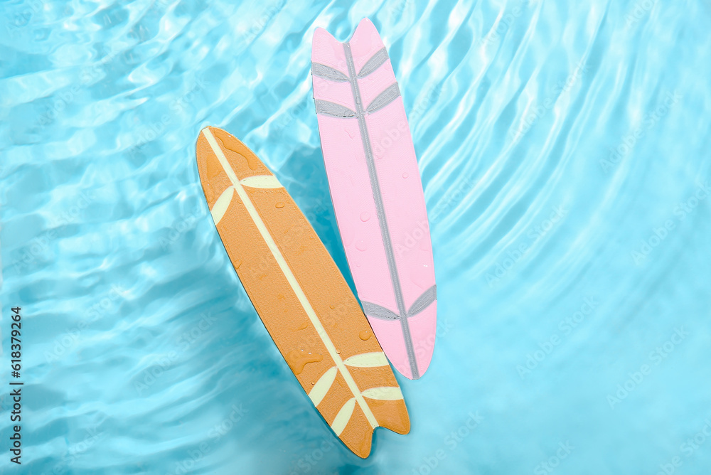 Different mini surfboards in water