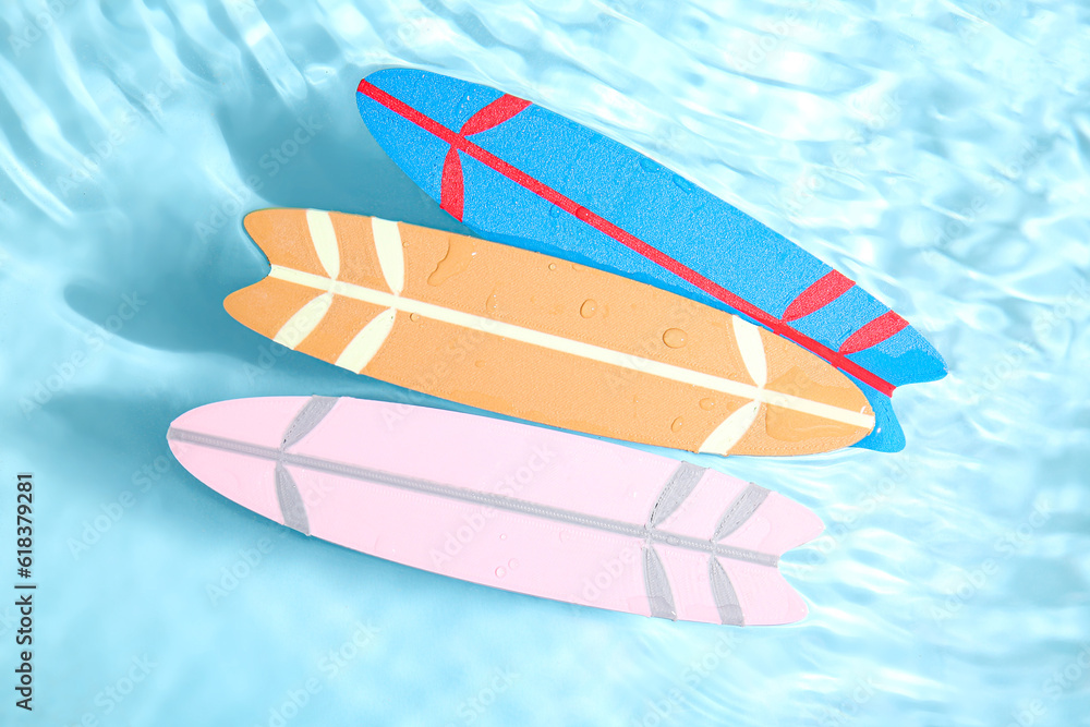 Different colorful mini surfboards in water