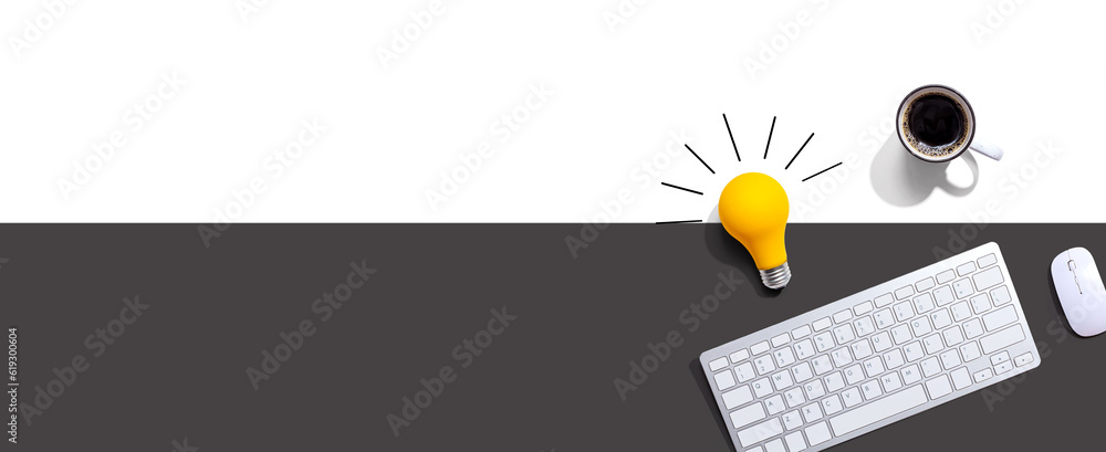 Computer keyboard with a yellow light bulb from above