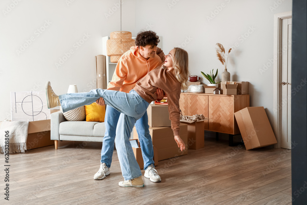 Young couple dancing in room on moving day