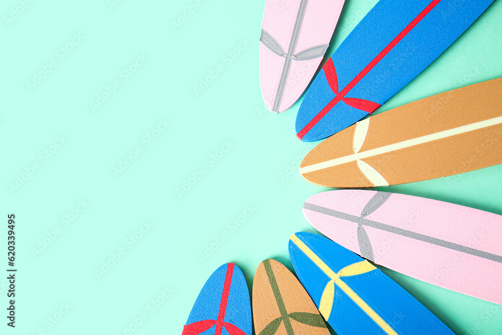 Many different mini surfboards on turquoise background