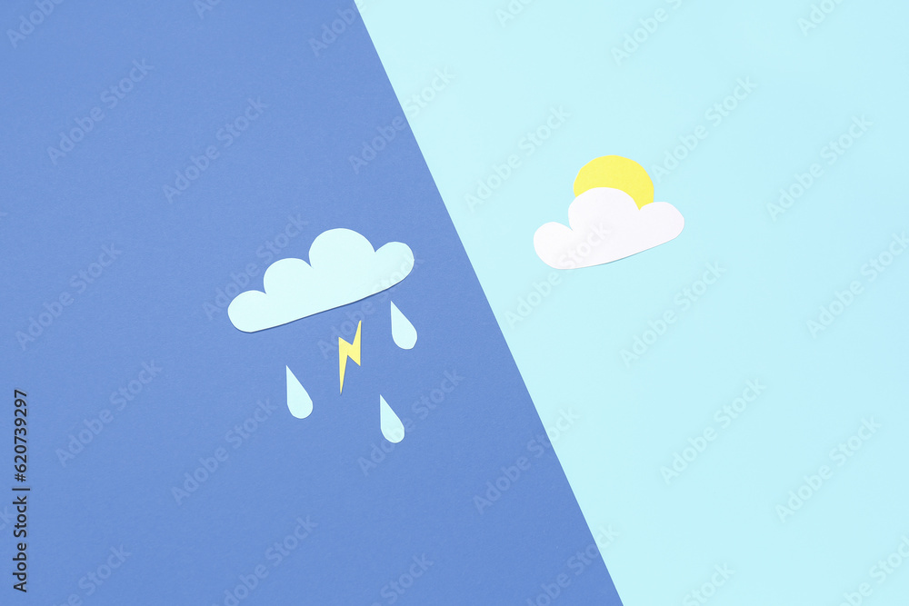 Paper clouds with rain drops, lightning and sun on blue background. Weather forecast concept