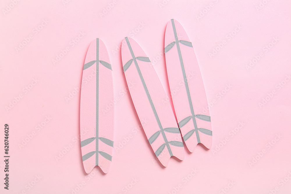 Mini surfboards on pink background
