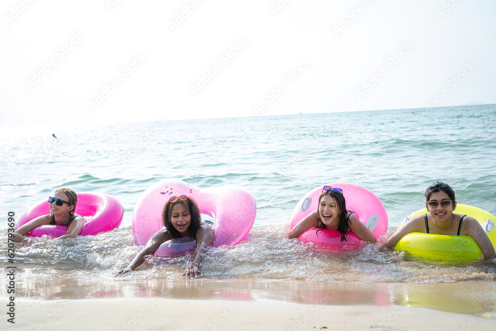 Group of happy friends having fun at ocean beach,Summer vacation.