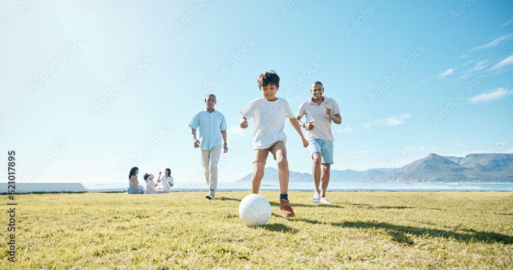 Family, soccer and men with ball in a park for fun, playing and bonding in nature on blue sky backgr