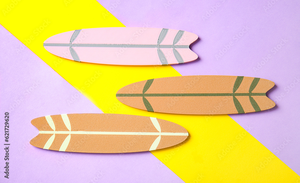 Different mini surfboards on color background
