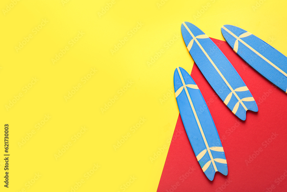 Mini surfboards on color background