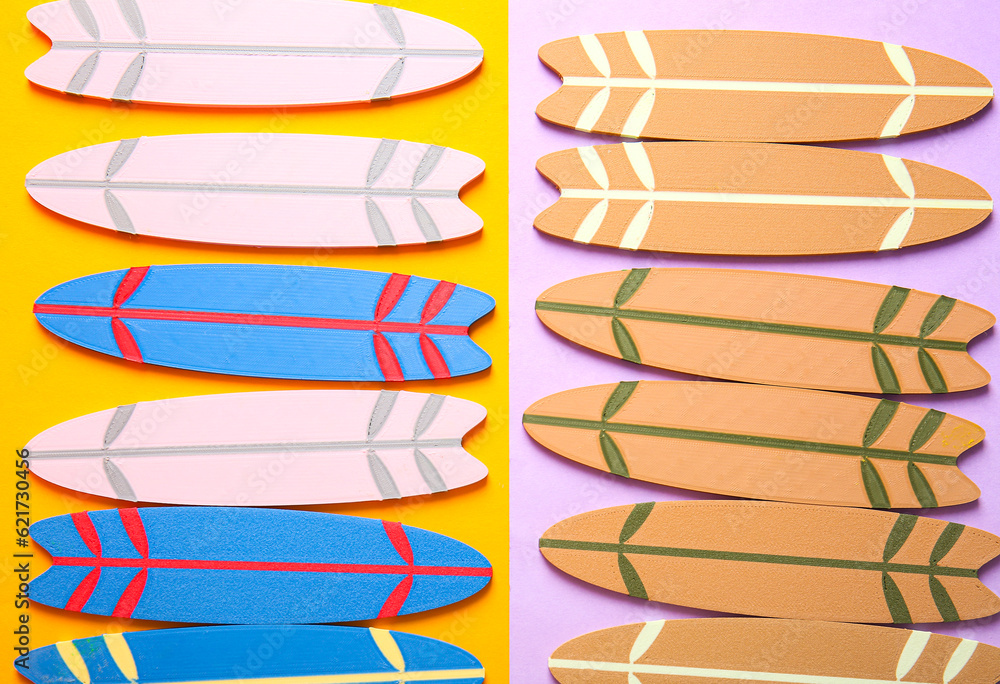 Many different mini surfboards on color background