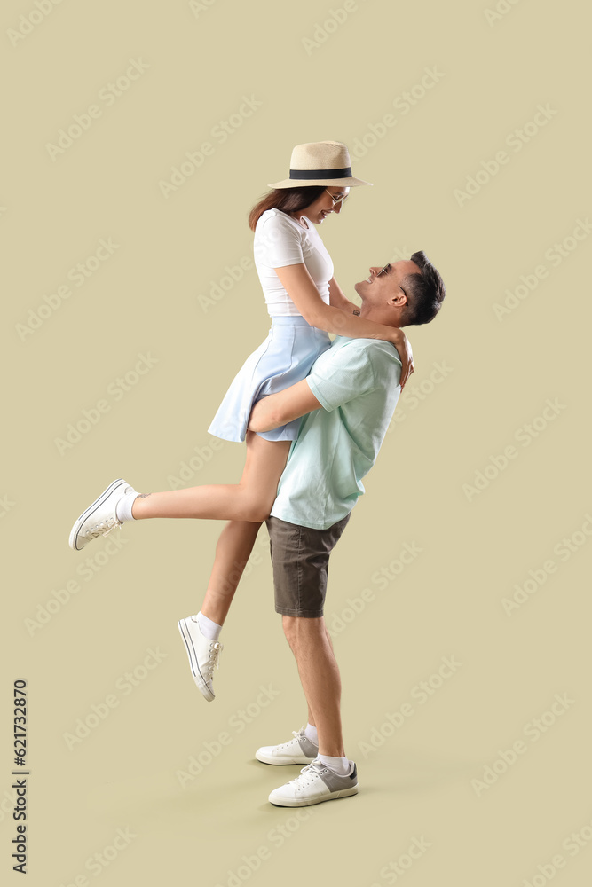 Happy young couple in summer clothes on green background