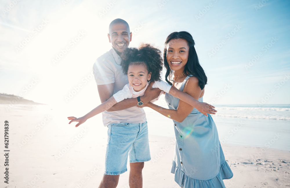 Beach, portrait and parents holding their child on the sand by the ocean on a family vacation. Happy