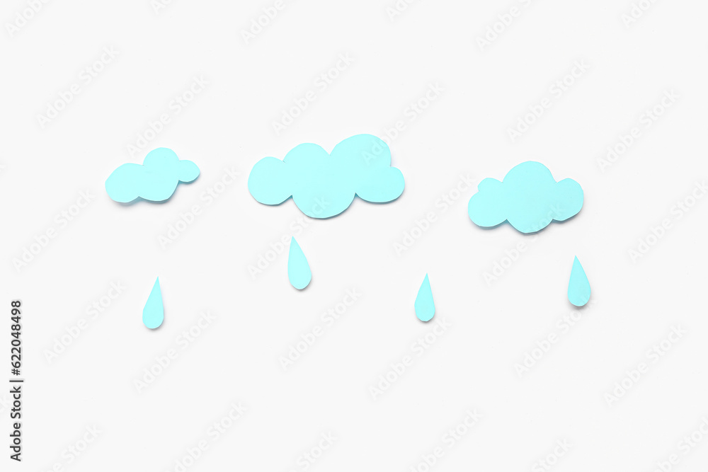 Paper clouds with rain drops on white background. Weather forecast concept