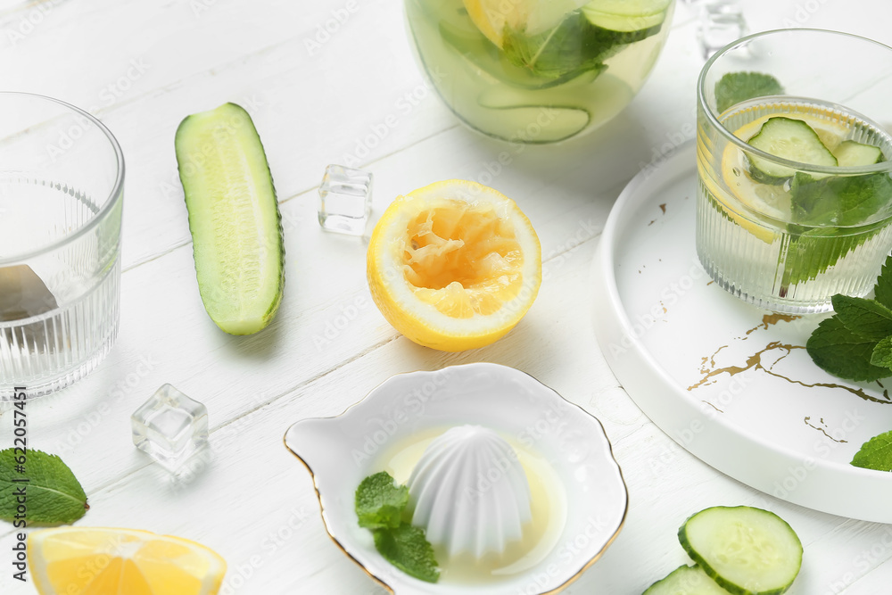 Glass of lemonade with cucumber and mint on white background