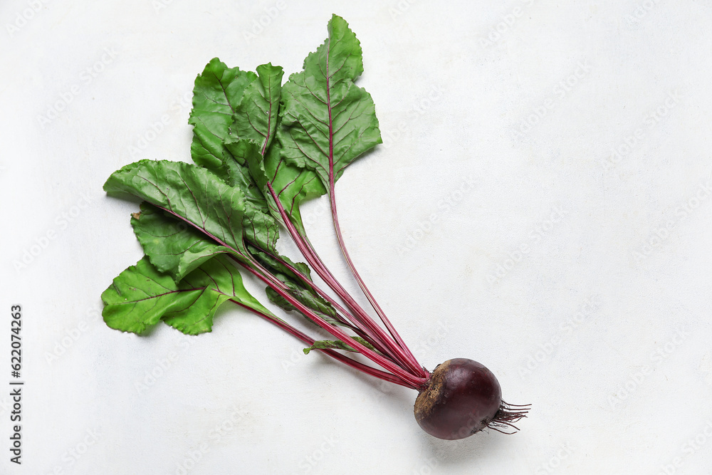 Fresh beetroot with leaves on white table