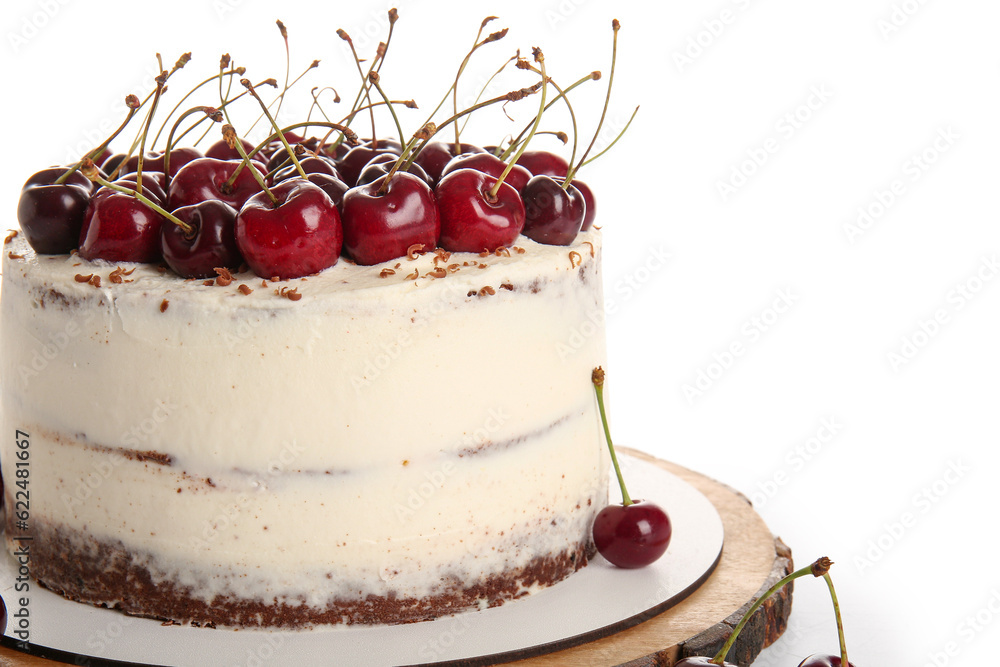 Wooden board with tasty cherry cake isolated on white background