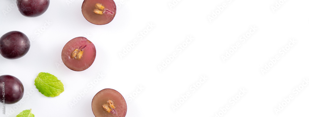 Delicious bunch of grapes fruit spilled over white table background.