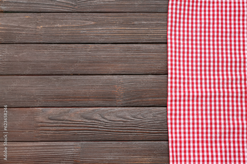 Red checkered napkin on dark wooden background