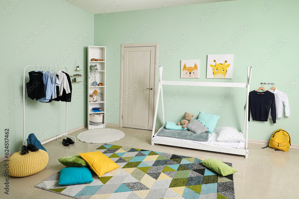 Stylish interior of childrens room with comfortable bed and school uniform