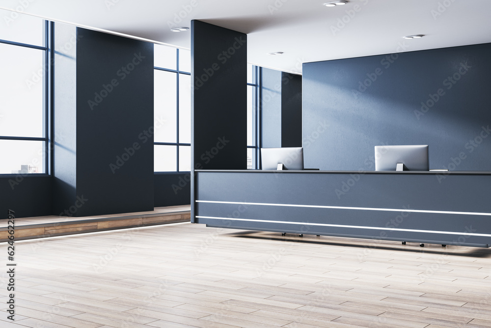 Clean concrete office lobby interior with reception desk and computer, wooden flooring, window with 