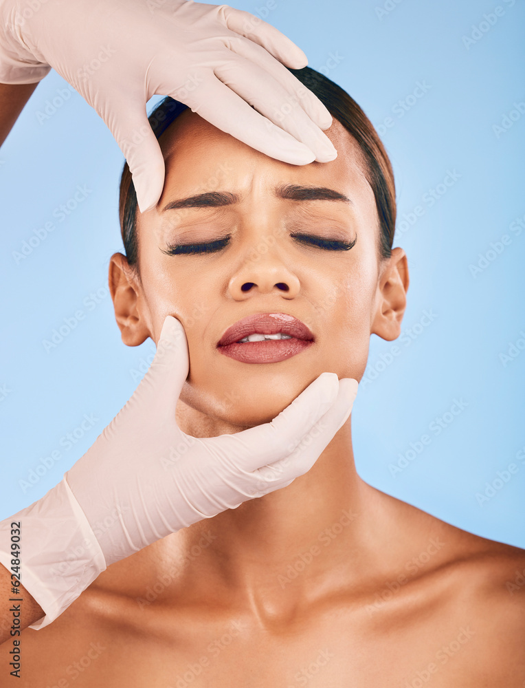 Plastic surgery, hands and woman in pain for skincare in studio isolated on a blue background. Beaut