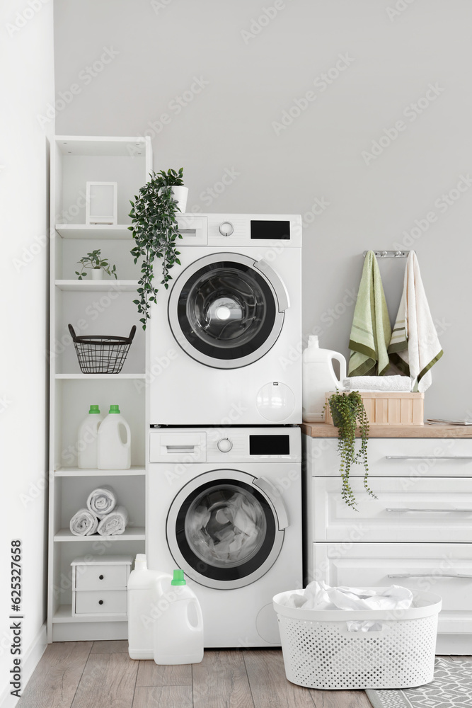 Laundry room with washing machines and white counters