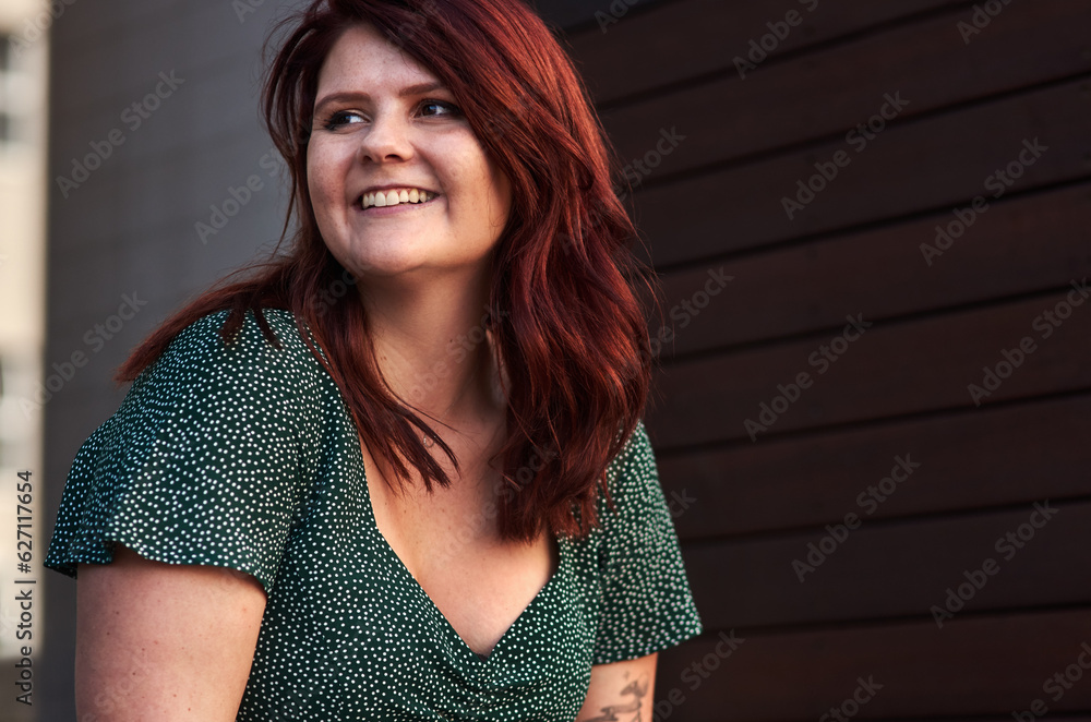 Red hair is like a crown you never take off. Cropped shot of a beautiful young woman posing outdoors