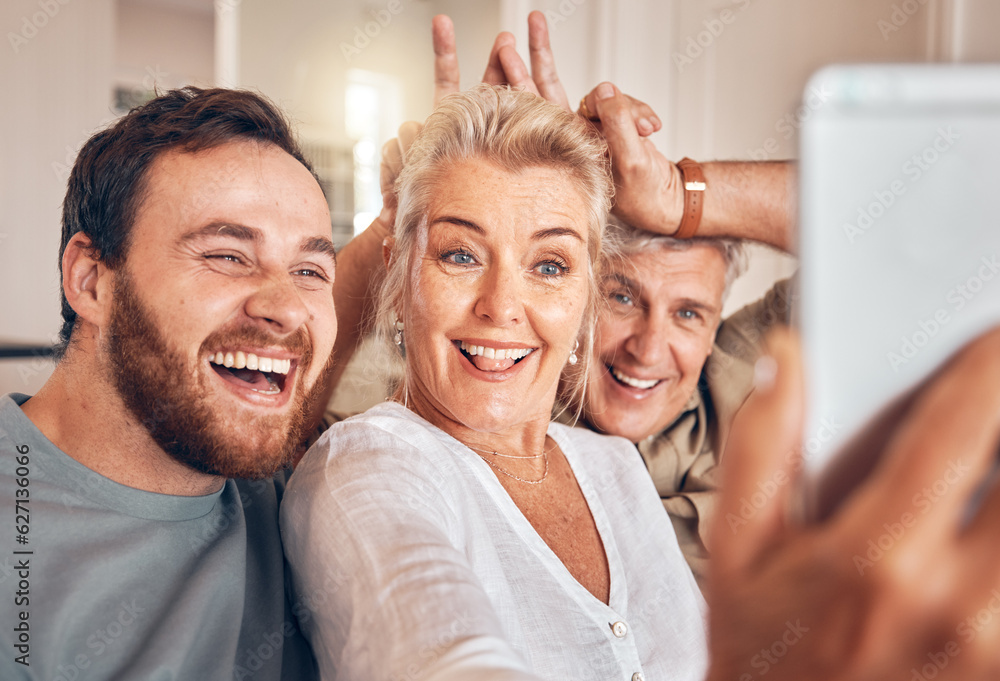 Man, senior parents and selfie in home, funny and peace sign for horns, bunny ears and laugh for pos